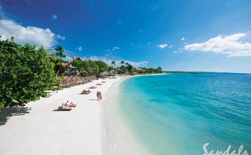 Sandals Negril- Negril Jamaica the beach with sandals negril in the background in negril jamaica