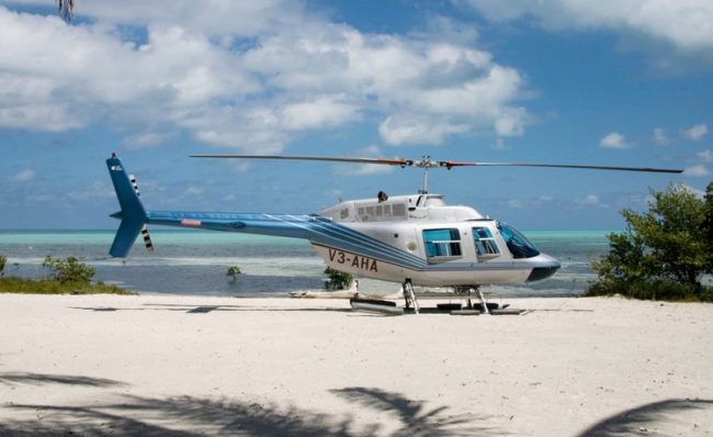 belize helicopters transfers belize helicopters on the beach waiting for clients