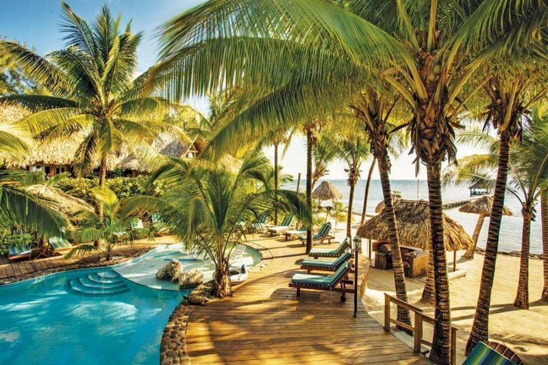 view of the beachfront pool with beach on the island of ambergris caye in belize