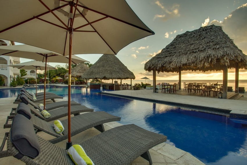 pool chair surrounding the beachfront pool and swim up bar at Umaya Resort in placencia