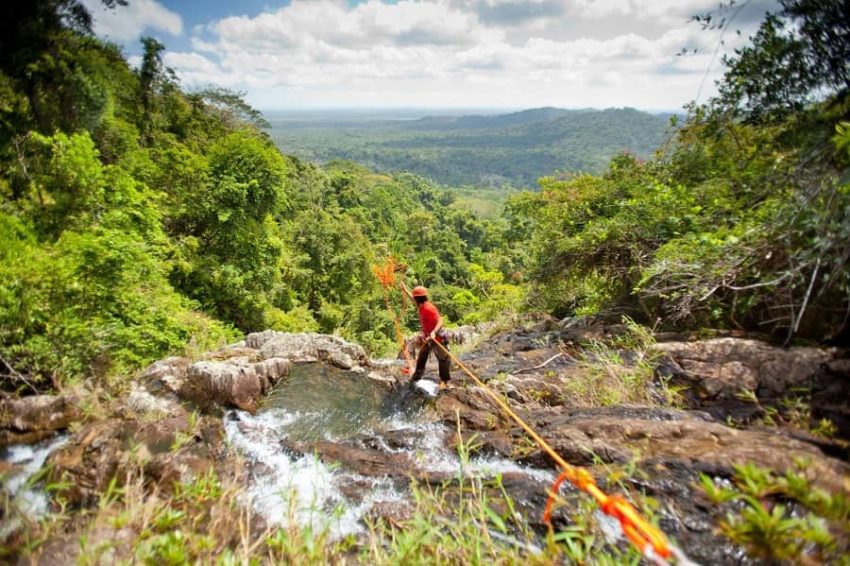 500ft Antelope waterfall rappelling, Bocawina guide gearing the rope on antelope fall at mayflower national park in belize