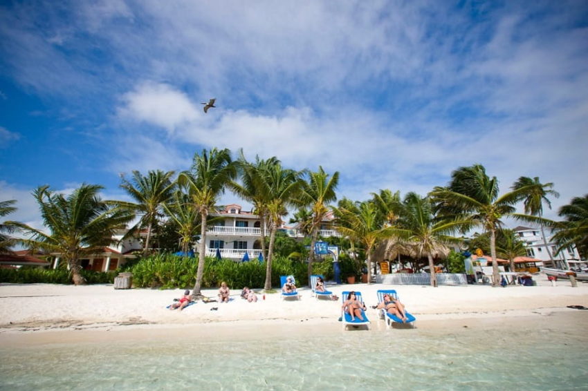 guests sunbathing on the beach infront off blue tang inn in downtown san pedro belize