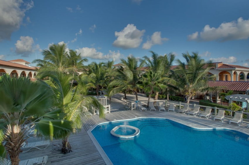 the courtyard with the pool and restaurant at sunbreeze hotel on the island of ambergris caye in belize