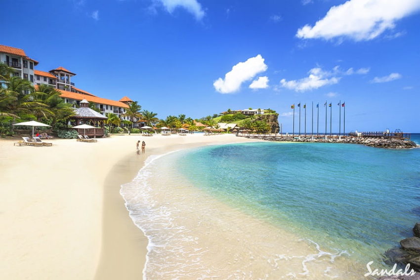 couple walking on the beach at sandals grenada in grenada