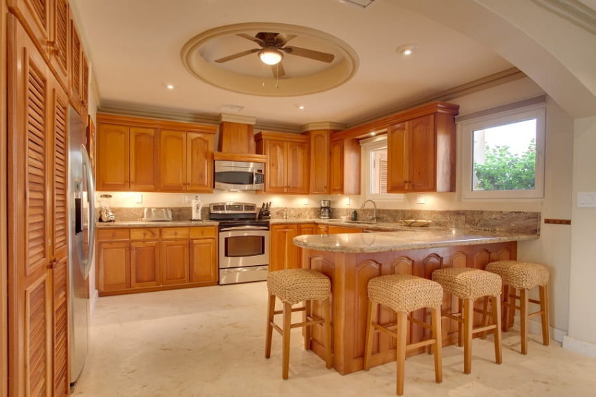 the kitchen with breakfast bar in the brushstrokes villa at belizean cove estates