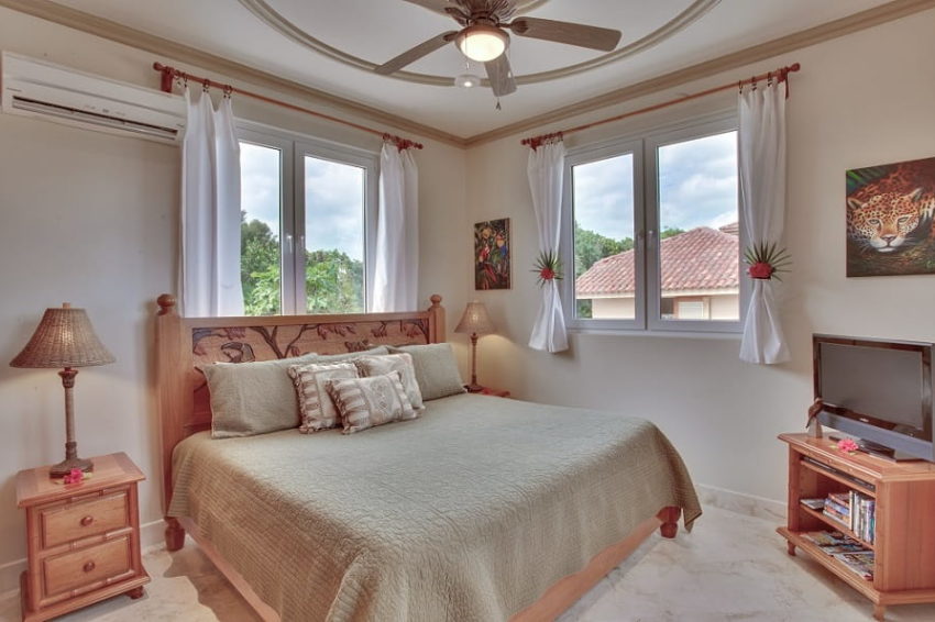 Villa Solemar, Belizean Cove Estate one of the bedroom with king bed and window that overlook the natural surroundings at villa solemar