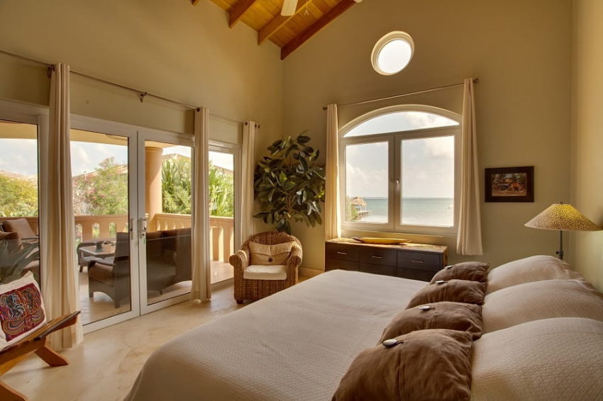 Villa Watina, Belizean Cove Estate the master bedroom featuring a private balcony overlooking the caribbean sea