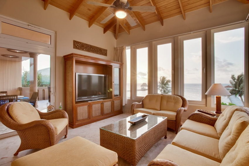 the living room with floor to ceiling windows that overlook the caribbean sea at villa del mar at belizean cove estate