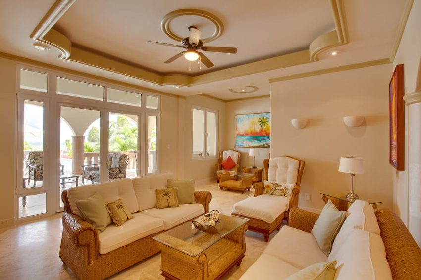 the living room with private balcony overlooking the caribbean sea and pool at belizean cove estate