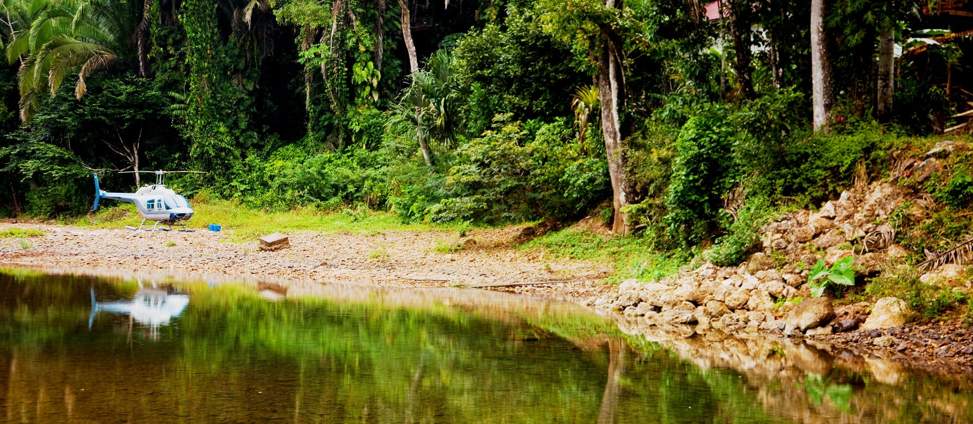 helicopter next to the cave branch river in belize