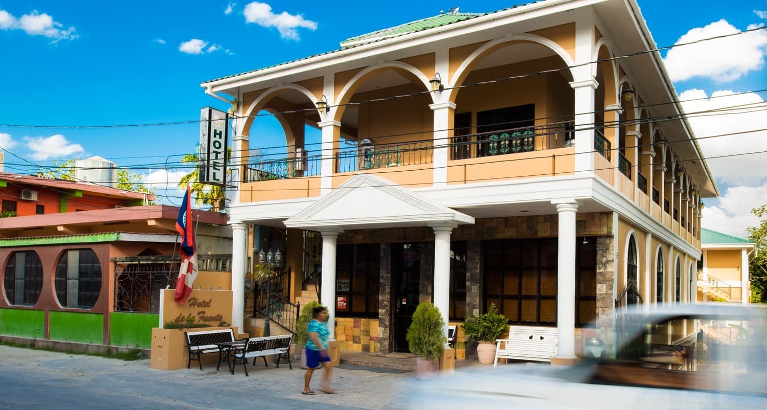 guest walking infront of hotel de la fuente in downtown orange walk belize