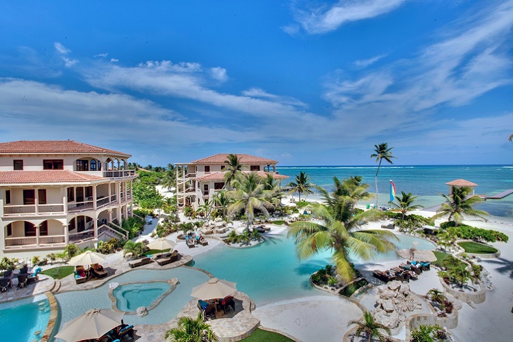 seaview, beachfront with the beachfront pool with coconut trees at coco beach resort on the island of ambergris caye