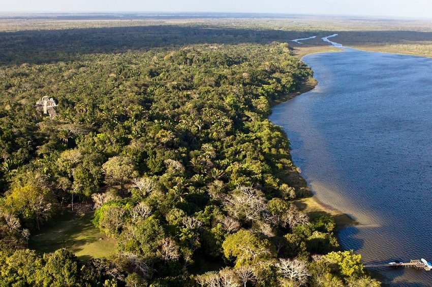 aerial view of lamanai in the jungle next to the new river lagoon in orange walk belize