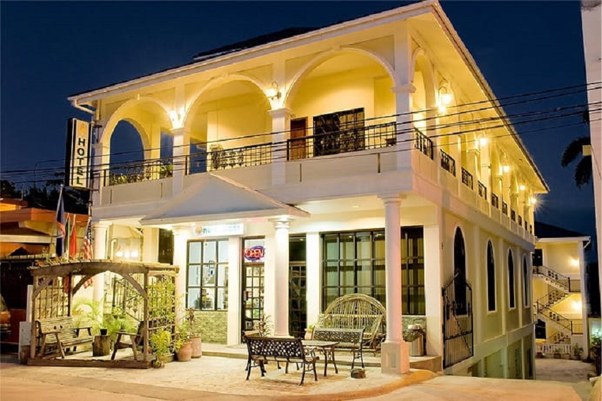 view of the front of hotel de la fuente at night in downtown orange walk belize